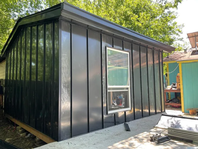 Black standing seam metal wall panels for Roof Inspection in Alafaya