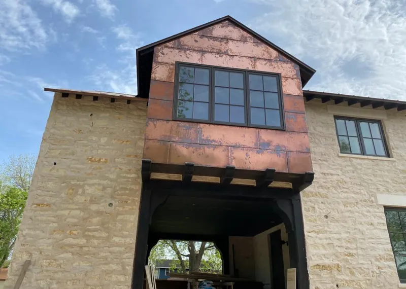 Copper metal panel facade on a stone building for Skylight Installation in Alafaya