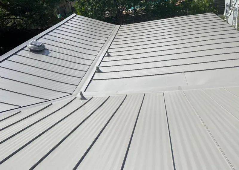 Solar attic fan installed on a metal roof for Roof Ventilation in Alafaya